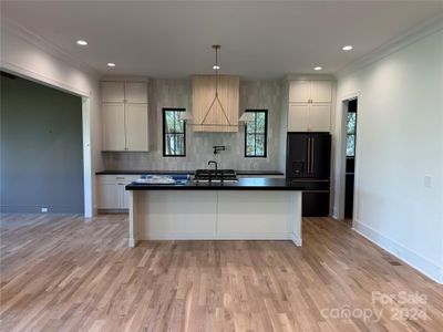 The range hood will be painted the same color as the cabinets.