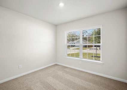 An additional bedroom with a beautiful window that provides natural lighting.