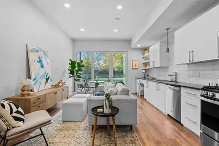 Living area with light wood-type flooring, baseboards, and recessed lighting