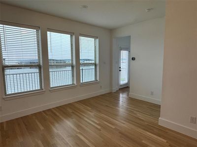 Empty room featuring baseboards and light wood finished floors