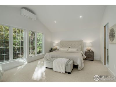 Private primary bedroom with wool carpet and Mitsubishi mini split.