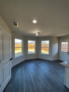 Dining area with windows allowing for more natural lighting, wood-type flooring