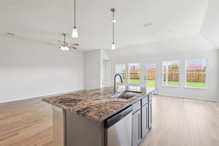 Kitchen with a kitchen island with sink, dishwasher, sink, ceiling fan, and light hardwood / wood-style floors