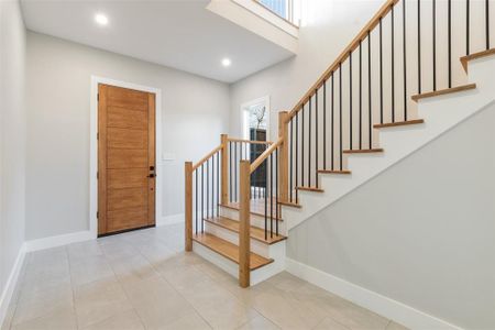 Stairs with tile patterned floors