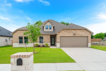 View of front of property featuring a garage and a front yard