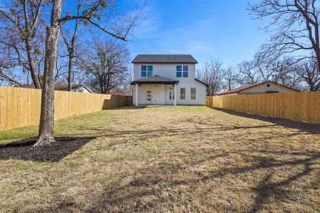 Back of house with a yard