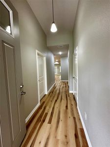 Corridor with hardwood / wood-style flooring