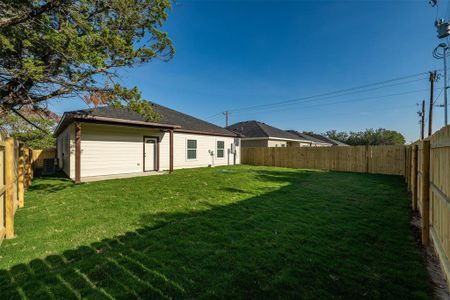 Rear view of house with a lawn and central air condition unit