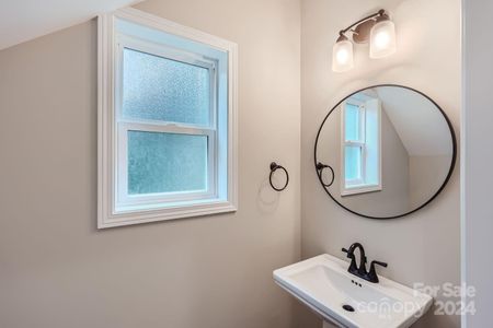 This charming half bathroom features modern fixtures, sleek finishes and a compact design for guest use.