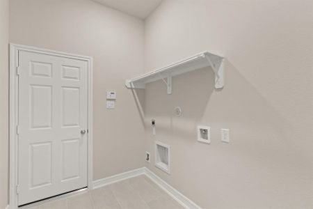 The laundry room layout is carefully planned for optimal workflow with designated areas for washing, drying, and storing.