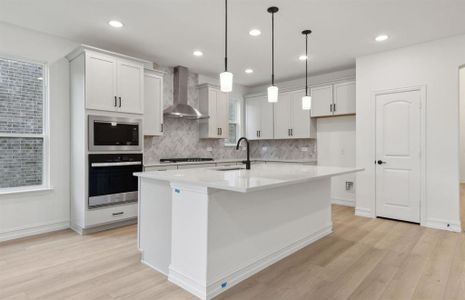 Bright kitchen with oversized island *real home pictured