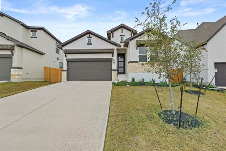 View of front of house with a garage and a front lawn