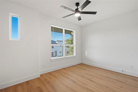 Unfurnished room with ceiling fan and light hardwood / wood-style floors