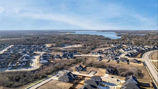 Birds eye view of property with a water view