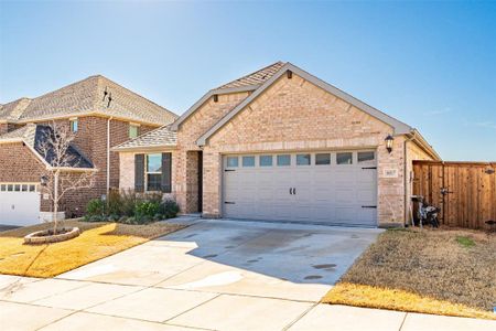 View of front of property with an attached garage, fence, concrete driveway, and brick siding