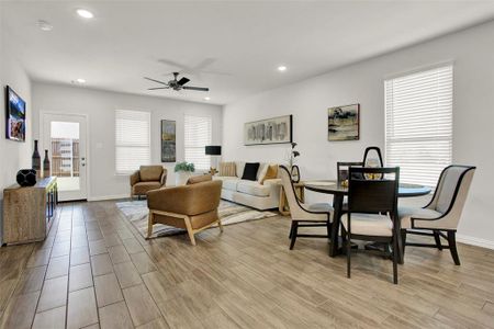 Living room featuring light hardwood / wood-style floors and ceiling fan