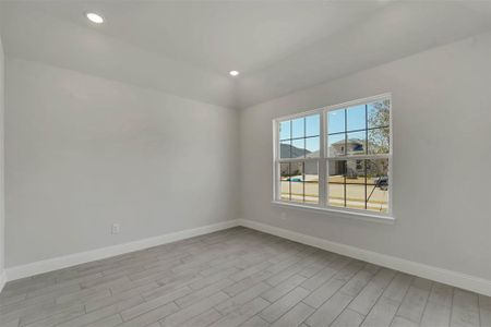 Empty room with baseboards, wood finished floors, and recessed lighting