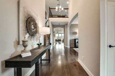 Entryway into foyer with two-story ceilings