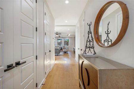 Hallway with light hardwood / wood-style floors