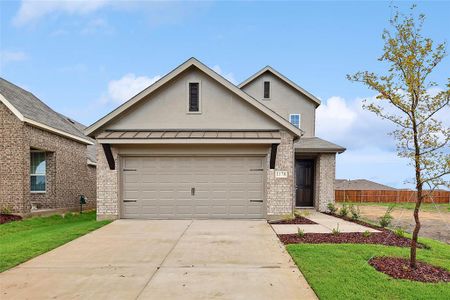 View of front facade featuring a front lawn and a garage