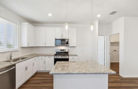 Bright kitchen with oversized island *real home pictured