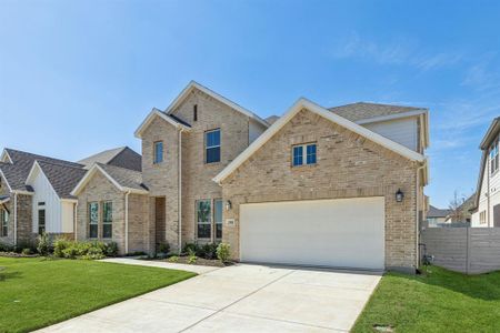 View of front of property featuring a front yard and a garage