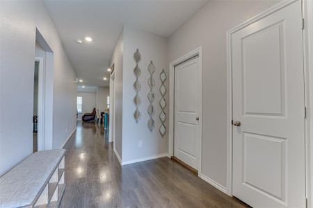 Hall with dark hardwood / wood-style flooring