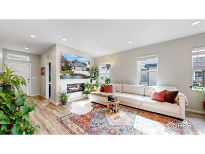 Open concept floor plan featuring LVP flooring, a gas fireplace in the living space and a walk-out patio.