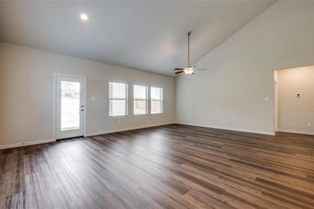 Unfurnished living room featuring high vaulted ceiling, ceiling fan, and wood-type flooring