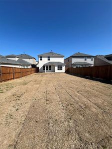 Back of property featuring a yard and a fenced backyard