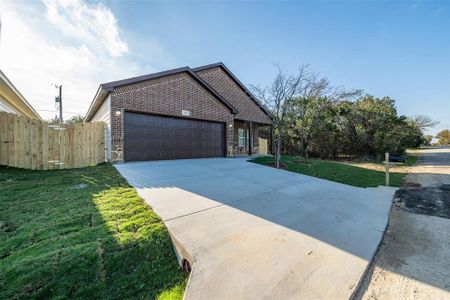 View of front of home with a garage and a front lawn