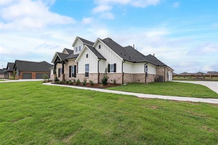 View of front of property with a garage and a front lawn