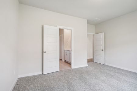 The primary bedroom of a home in Pine Lake Cove of Conroe, TX.