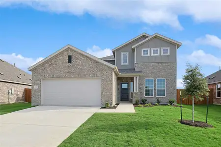 View of front of property with a garage and a front lawn