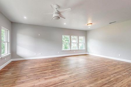 Spare room featuring light hardwood / wood-style floors and ceiling fan