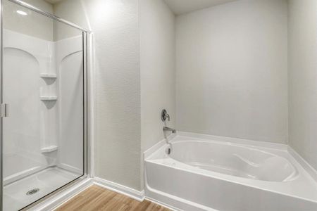 Check out the soaking tub and upgraded shower in the master bedroom!