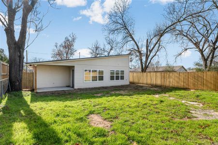 Rear view of house with a lawn and a patio area