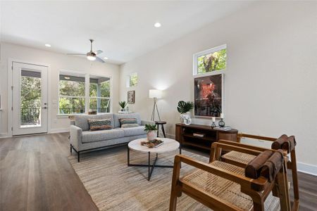 Open layout leads to covered back porch and lush, private, fenced backyard.