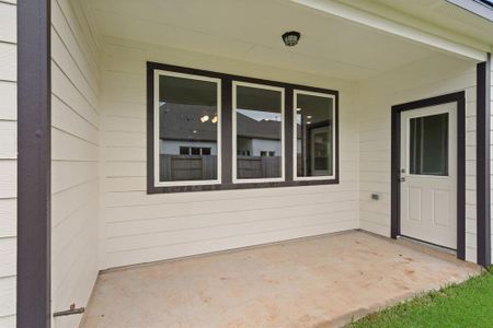 The covered patio is generously sized, providing ample space for various outdoor activities.