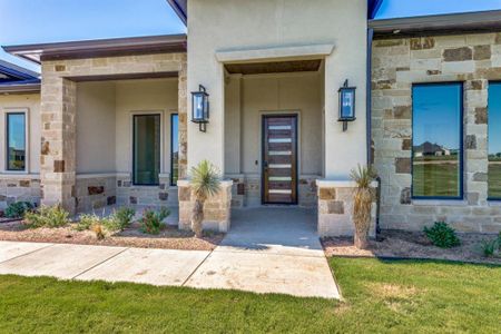 View of exterior entry with landscaping