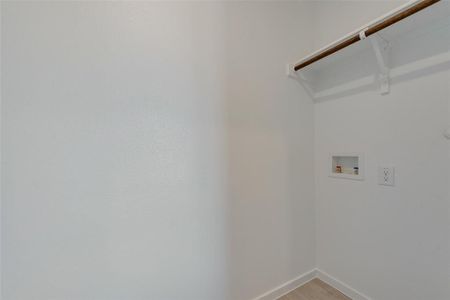 Laundry room with hardwood / wood-style flooring and washer hookup