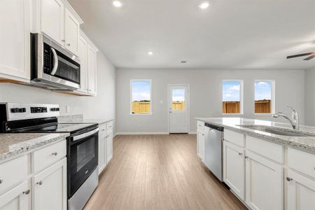 The kitchen has a bright and inviting view of the backyard and includes brand new Whirlpool appliances.