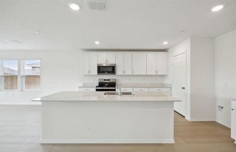 Bright kitchen with oversized island  *real home pictured