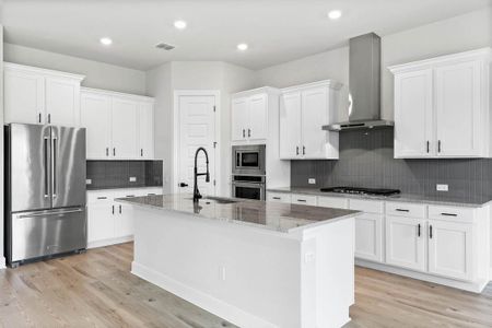 The kitchen comes equipped with upgraded, Kitchen Aid stainless steel appliances, a gorgeous center island, and French-door refrigerator.