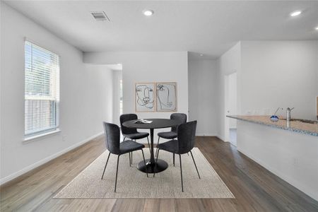 Start your day off right with a cup of coffee sitting with your family in the lovely dining area! Featuring large window with blinds, custom neutral paint, vinyl plank flooring, recessed lighting and high ceilings!