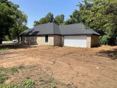 View of side of home with a garage