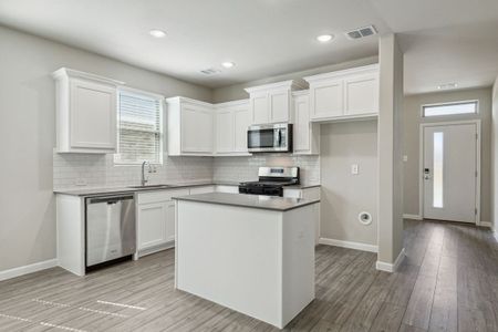 Kitchen in the Pearl home plan by Trophy Signature Homes – REPRESENTATIVE PHOTO