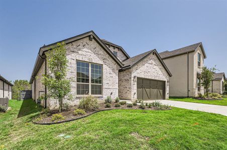 View of front of house featuring a garage and a front lawn