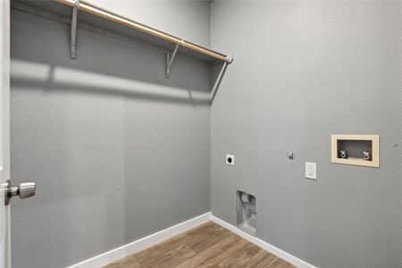 Clothes washing area featuring washer hookup, hardwood / wood-style flooring, hookup for an electric dryer, and gas dryer hookup