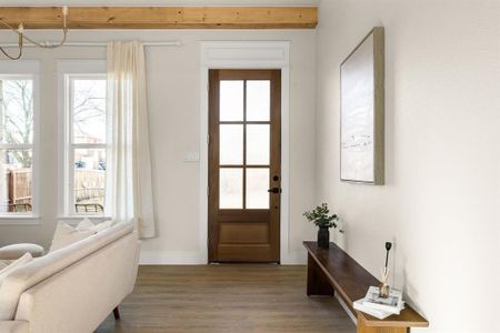 Entryway featuring a wealth of natural light, baseboards, and wood finished floors